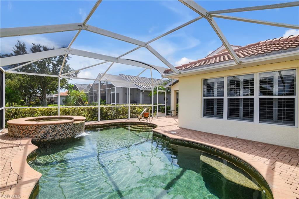 19633 Villa Rosa Loop Estero, FL 33967 - Photo 29 of 50 View of swimming pool with glass enclosure, a patio area, and an in ground hot tub