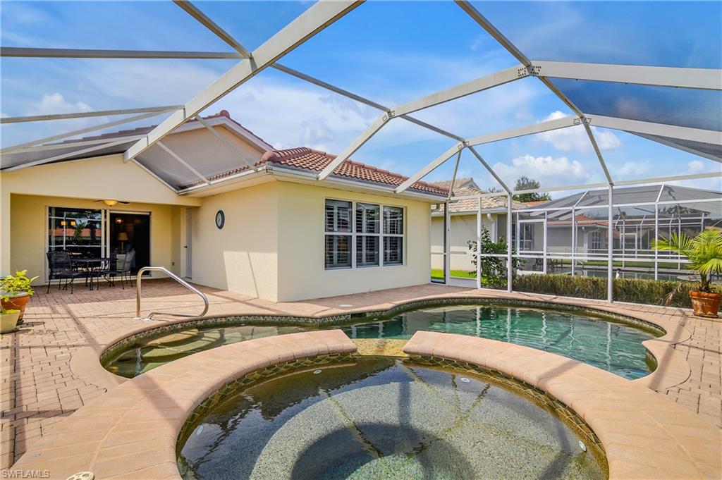 19633 Villa Rosa Loop Estero, FL 33967 - Photo 30 of 50 View of pool featuring glass enclosure, a patio, and an in ground hot tub