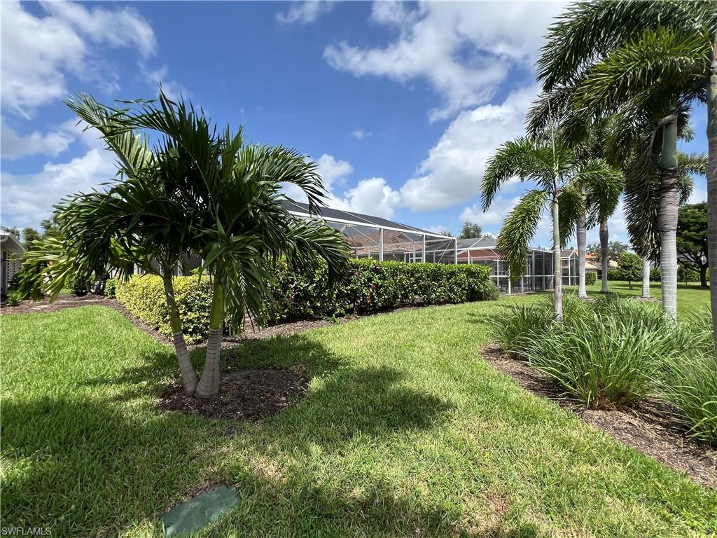19633 Villa Rosa Loop Estero, FL 33967 - Photo 32 of 50 View of yard with glass enclosure