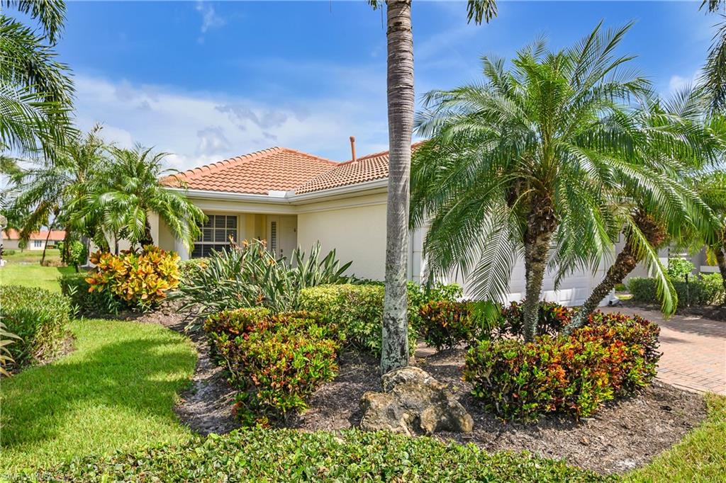 19633 Villa Rosa Loop Estero, FL 33967 - Photo 4 of 50 View of property exterior featuring a lawn