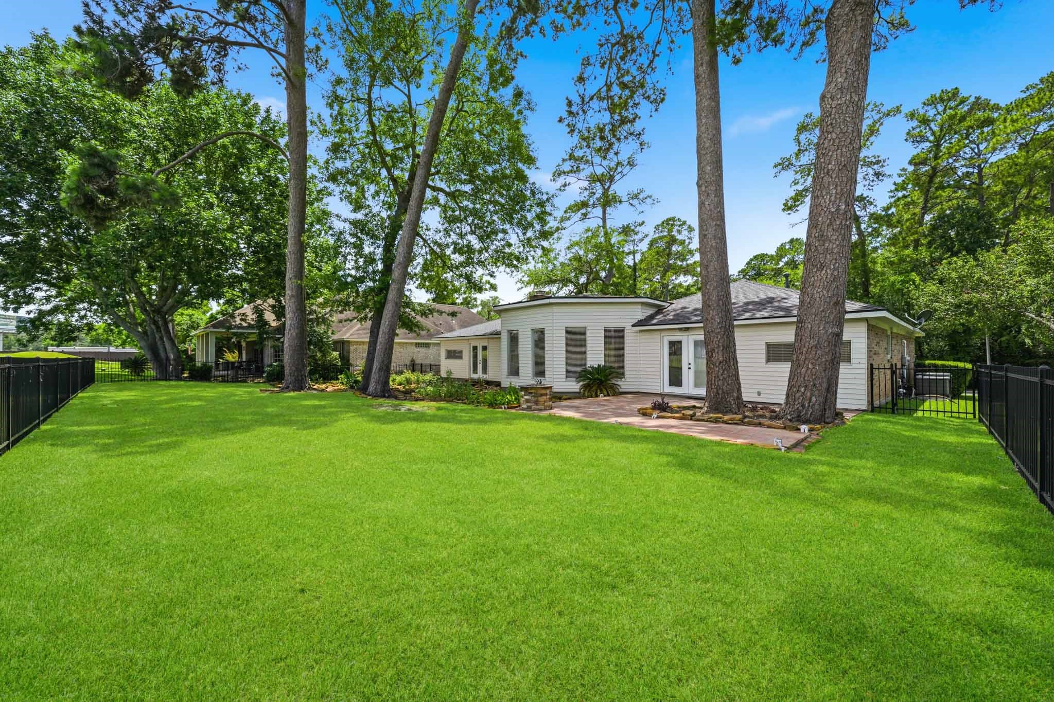 79 Summers Wind Street Conroe, TX 77356 - Photo 36 of 45 a view of a house with backyard and a tree