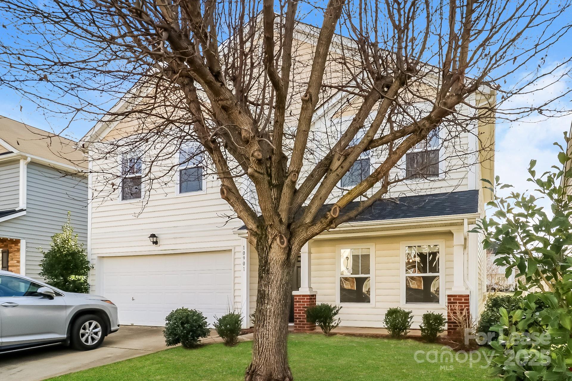 10901 Slalom Hill Road Charlotte, NC 28278 - Photo 2 of 17 a view of a white house next to a yard with big trees