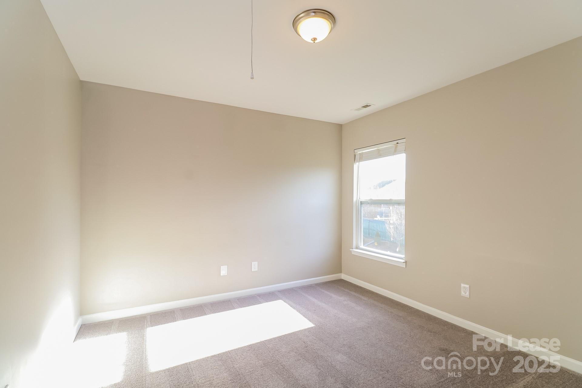 10901 Slalom Hill Road Charlotte, NC 28278 - Photo 10 of 17 a view of an empty room with a window
