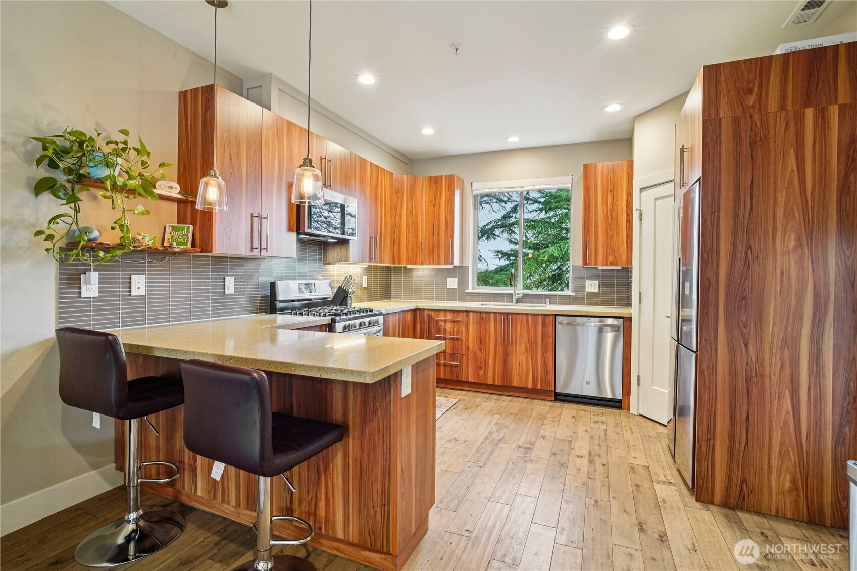 301 South 47th Street, Unit B Renton, WA 98055 - Photo 11 of 32 a kitchen with stainless steel appliances granite countertop a sink a stove a refrigerator and island with wooden floor