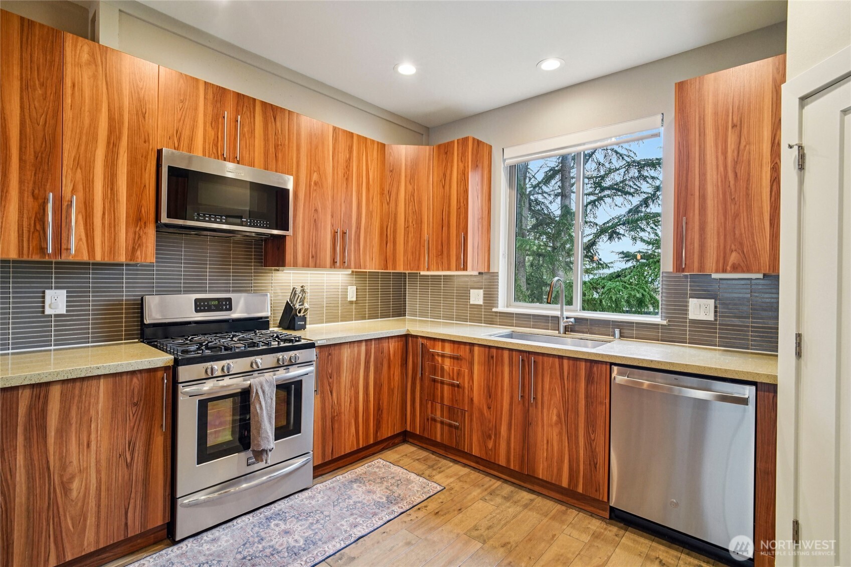 301 South 47th Street, Unit B Renton, WA 98055 - Photo 12 of 32 a kitchen with a stove microwave and sink