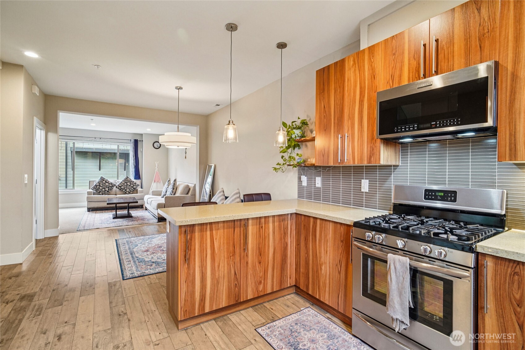301 South 47th Street, Unit B Renton, WA 98055 - Photo 13 of 32 a kitchen with stainless steel appliances a stove a microwave and sink