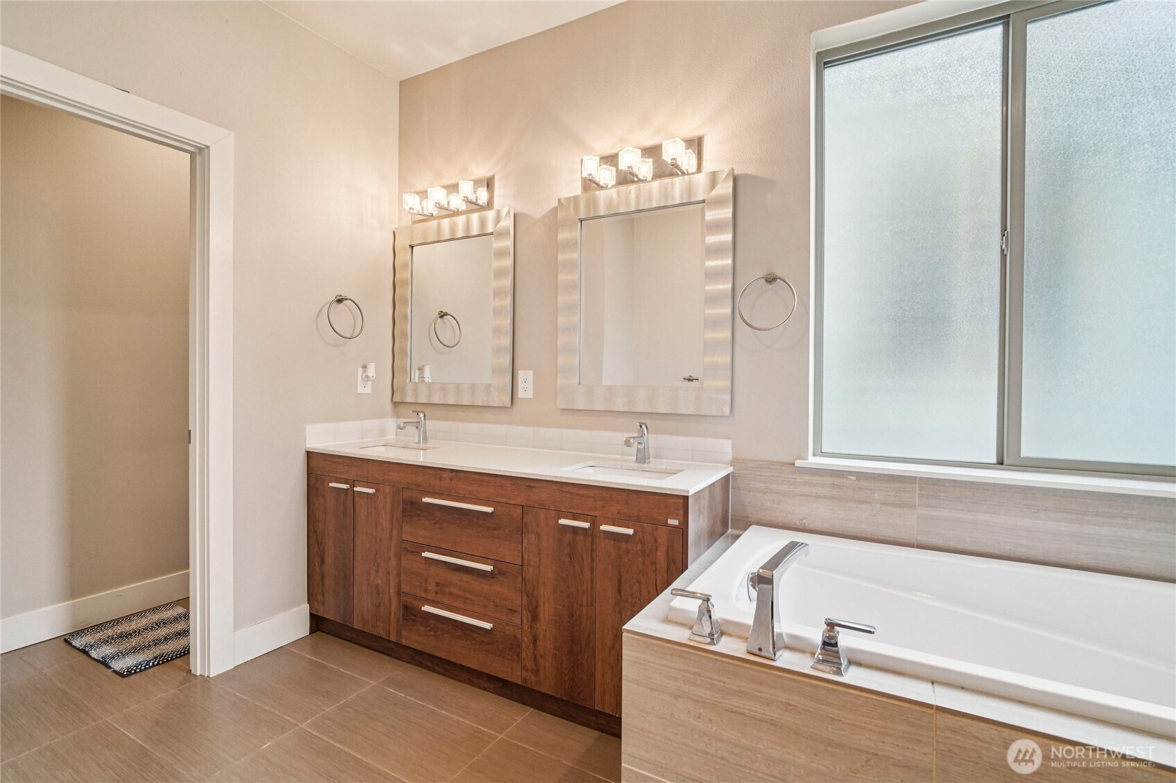 301 South 47th Street, Unit B Renton, WA 98055 - Photo 19 of 32 a bathroom with a tub sink and mirror