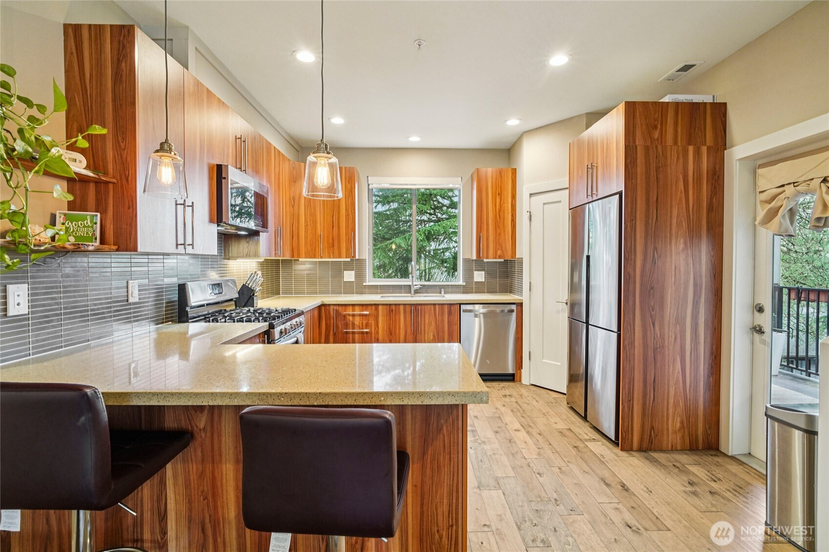 301 South 47th Street, Unit B Renton, WA 98055 - Photo 10 of 32 a kitchen with a table chairs sink refrigerator and microwave