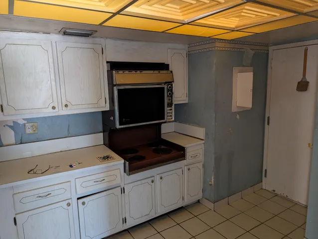 a kitchen with a stove refrigerator and cabinets