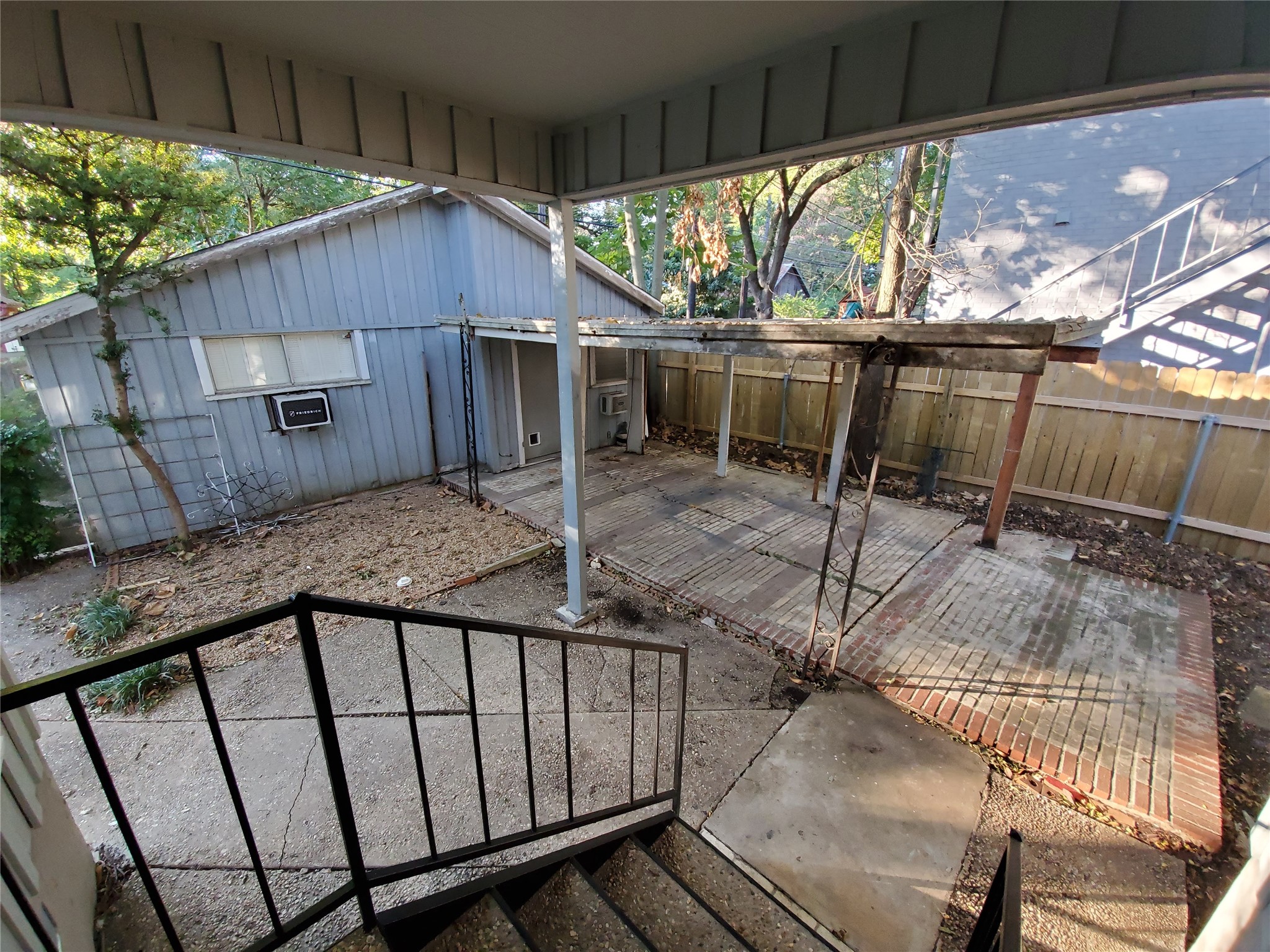 4113 Speedway Austin, TX 78751 - Photo 21 of 31 Concrete steps descend to a brick patio shaded by a covered arbor in the yard.