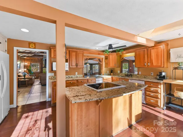 a kitchen with stainless steel appliances granite countertop a sink and cabinets