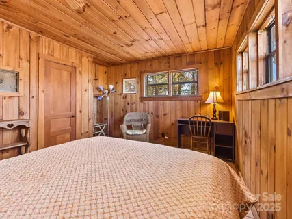 a bedroom with a large bed and a dresser