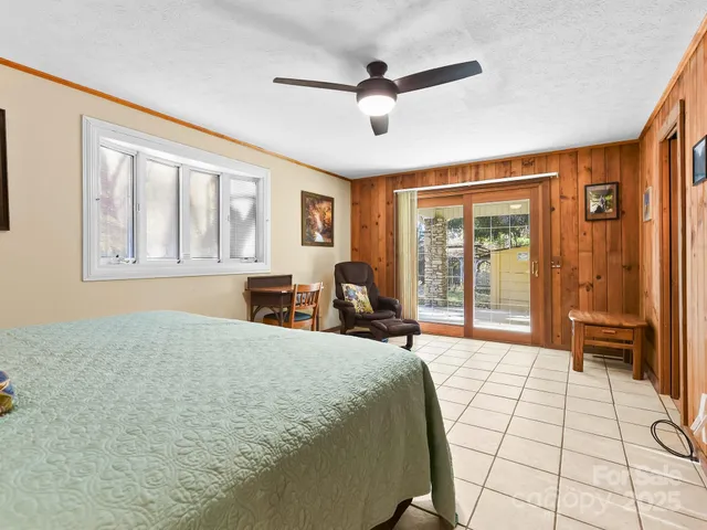 a bedroom with a bed and glass walk in closet