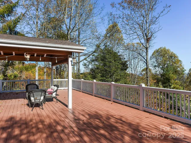 a view of a patio with a table chairs and wooden fence