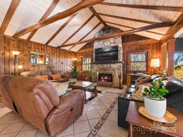 a living room with furniture a fireplace and a table