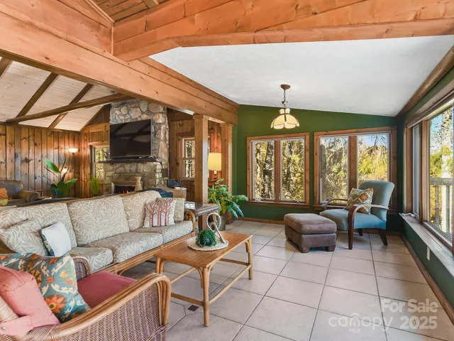a living room with patio furniture and a large window