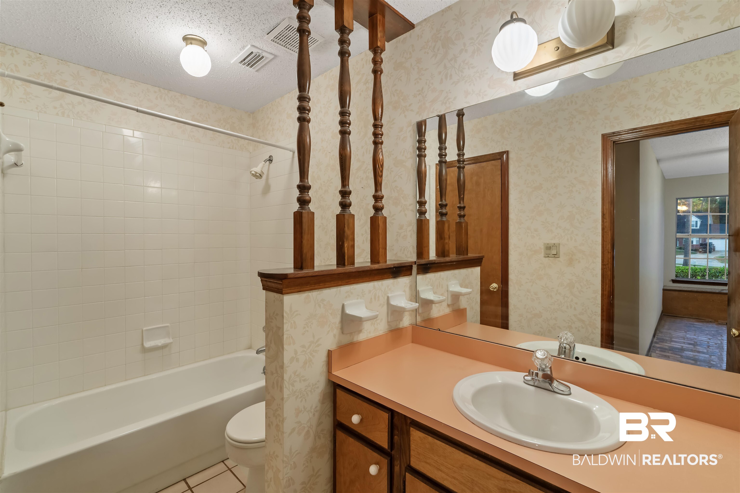 438 Ridgewood Drive Daphne, AL 36526 - Photo 17 of 28 Full bathroom featuring tiled shower / bath, vanity, a textured ceiling, toilet, and tile patterned floors