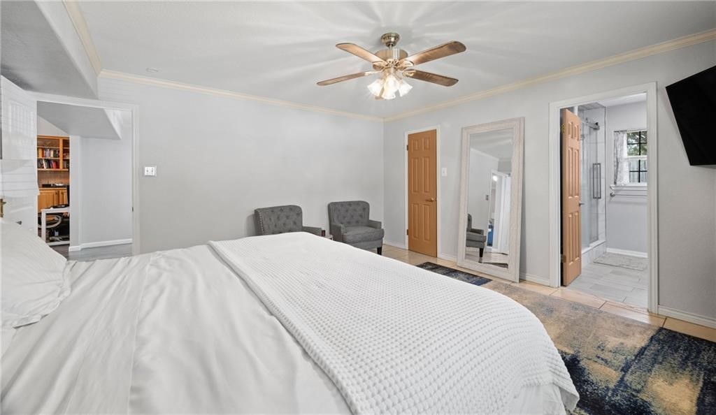 5337 Inverness Drive Corpus Christi, TX 78413 - Photo 17 of 32 a bedroom with a bed and a chandelier