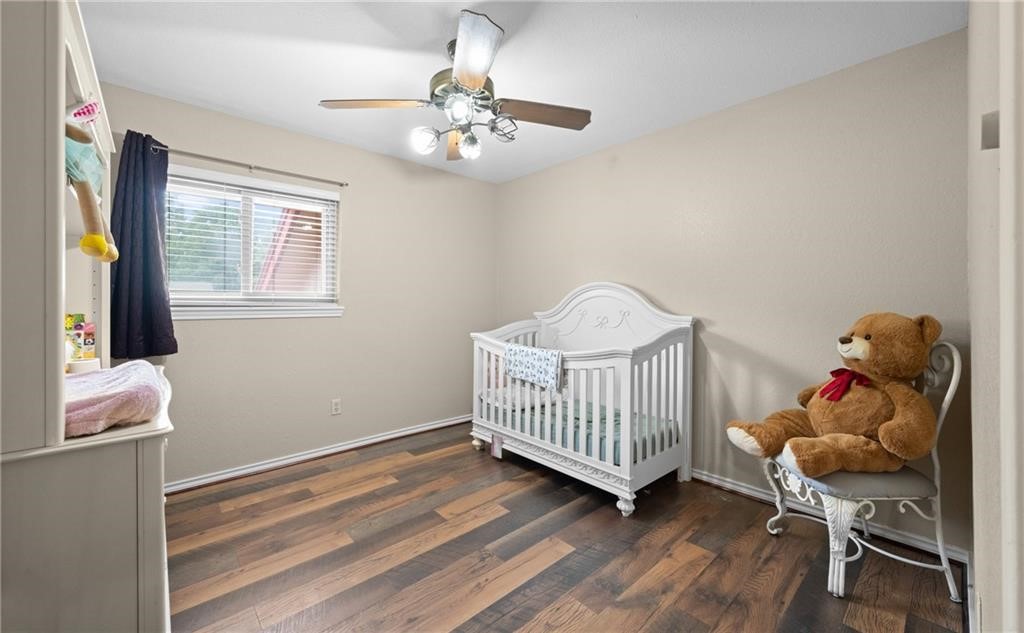 5337 Inverness Drive Corpus Christi, TX 78413 - Photo 21 of 32 a bedroom with a bed and wooden floor