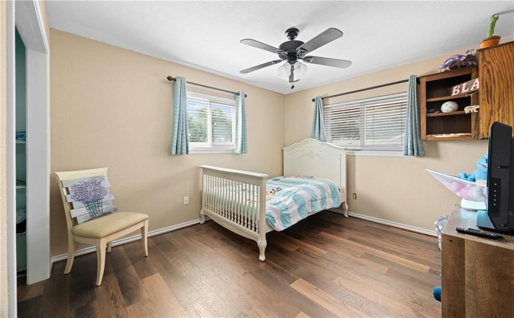 5337 Inverness Drive Corpus Christi, TX 78413 - Photo 22 of 32 a bedroom with a bed wooden floor and window