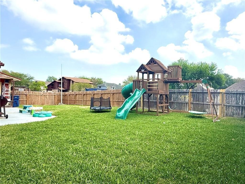 5337 Inverness Drive Corpus Christi, TX 78413 - Photo 26 of 32 a view of a house with a backyard and a slide
