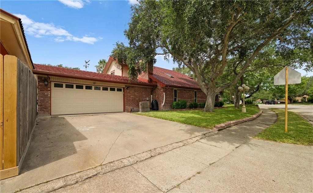 5337 Inverness Drive Corpus Christi, TX 78413 - Photo 29 of 32 a front view of a building with a garden and trees