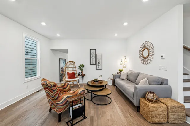 a living room with furniture a rug and a window