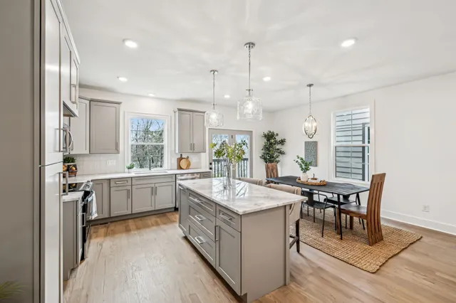a kitchen with center island table and chairs in it
