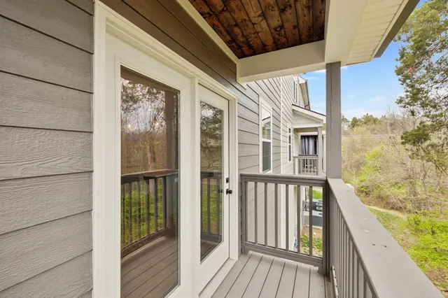 a view of a balcony with wooden floor