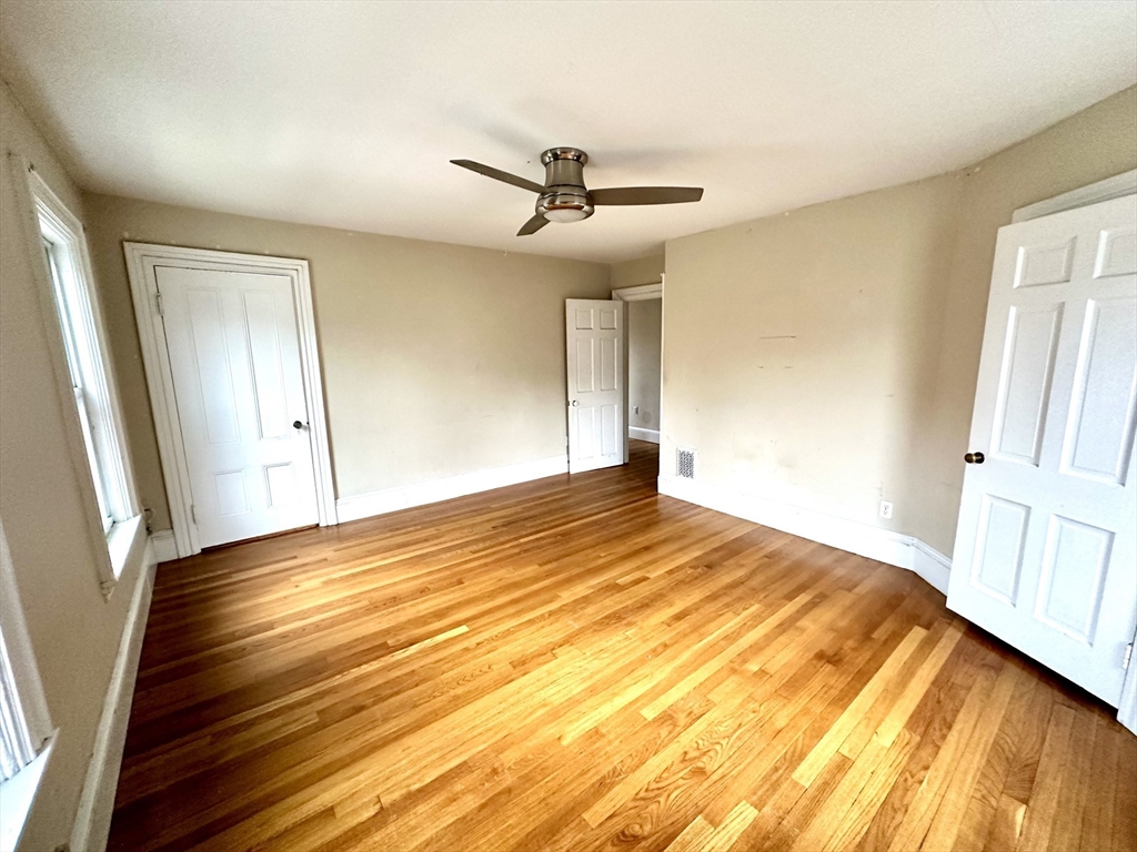 6 Grant Street, Unit 2 Natick, MA 01760 - Photo 11 of 15 a view of empty room with wooden floor