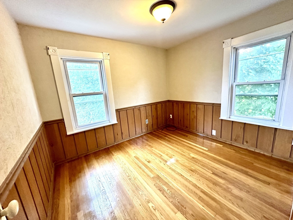 6 Grant Street, Unit 2 Natick, MA 01760 - Photo 12 of 15 a view of a room with wooden floor and windows