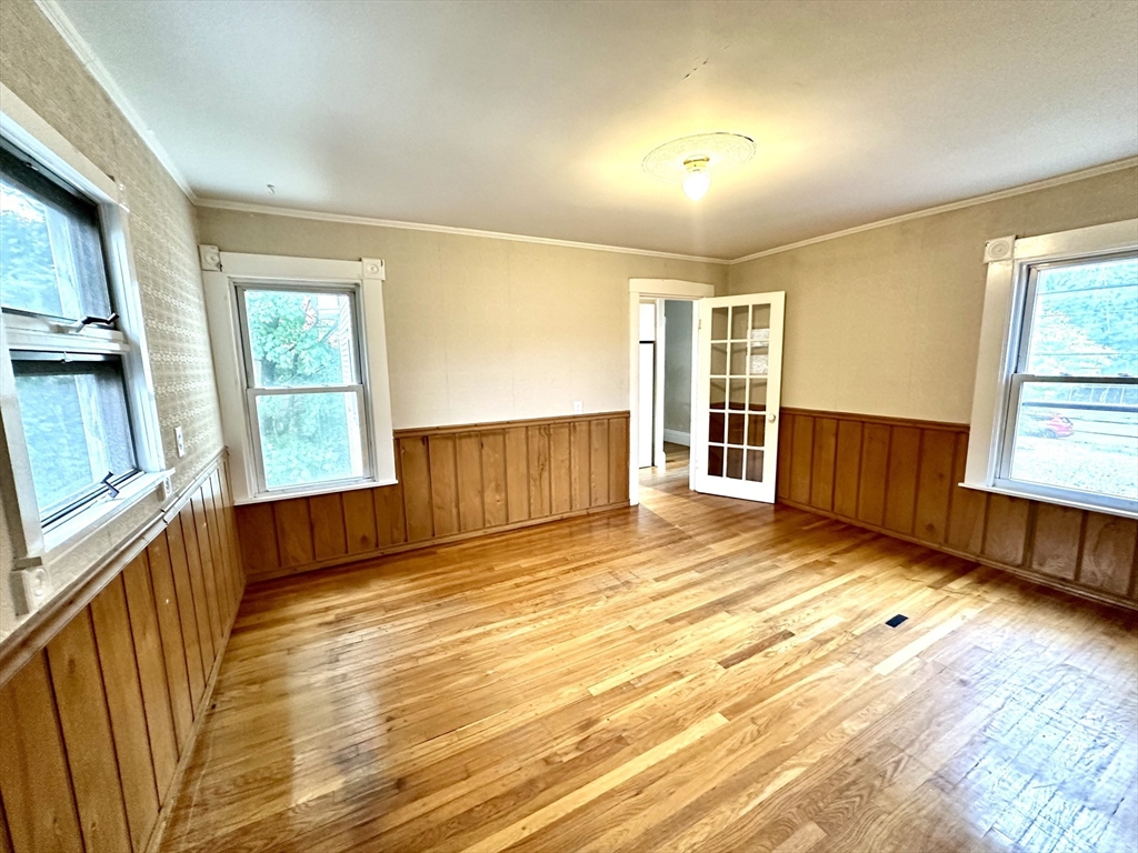 6 Grant Street, Unit 2 Natick, MA 01760 - Photo 6 of 15 a view of empty room with wooden floor and fan