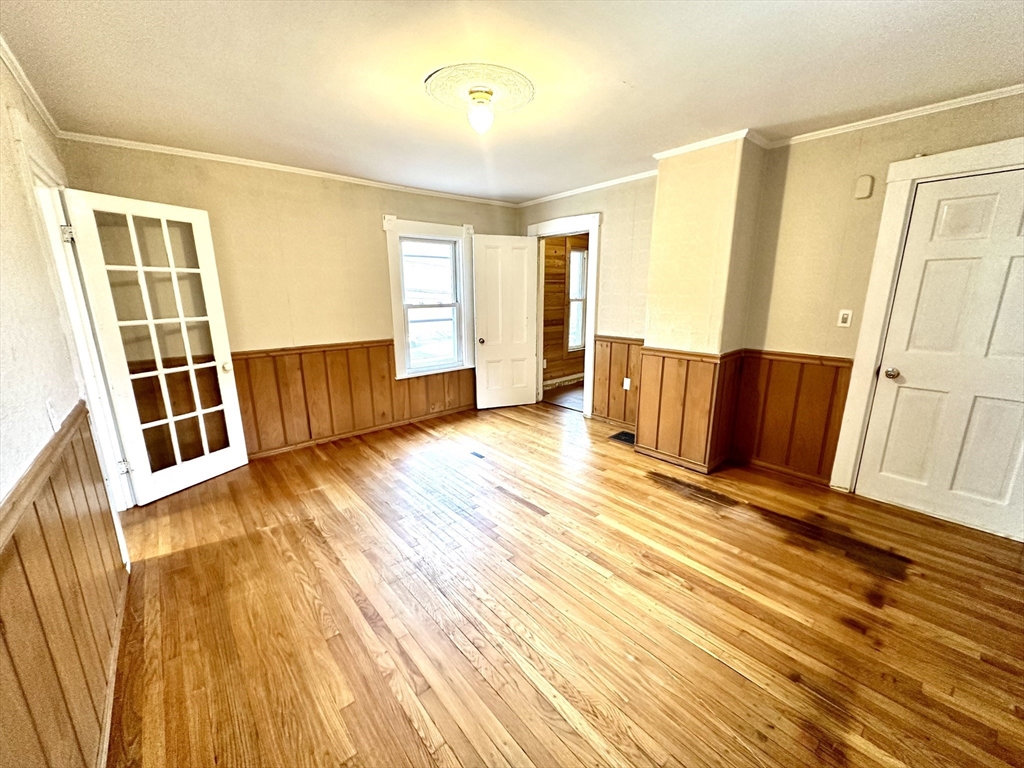 6 Grant Street, Unit 2 Natick, MA 01760 - Photo 7 of 15 a view of a room with wooden floor and door