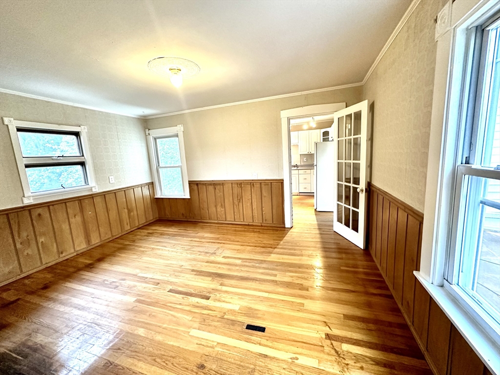 6 Grant Street, Unit 2 Natick, MA 01760 - Photo 8 of 15 a view of a room with wooden floor and windows