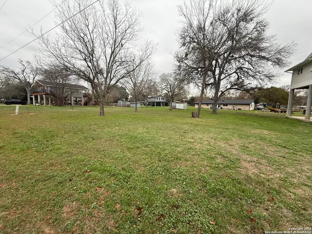 a backyard of apartments with large trees