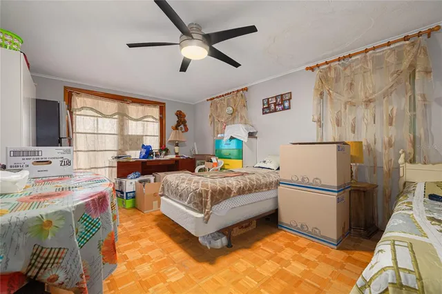 a bedroom with a bed and a large window