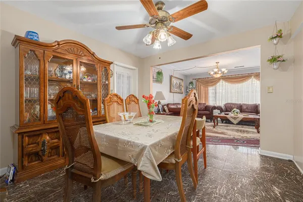 a view of a dining room with furniture and chandelier
