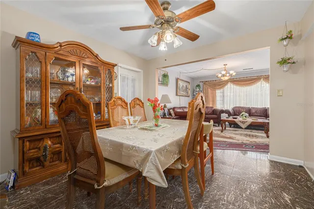 a view of a dining room with furniture and chandelier