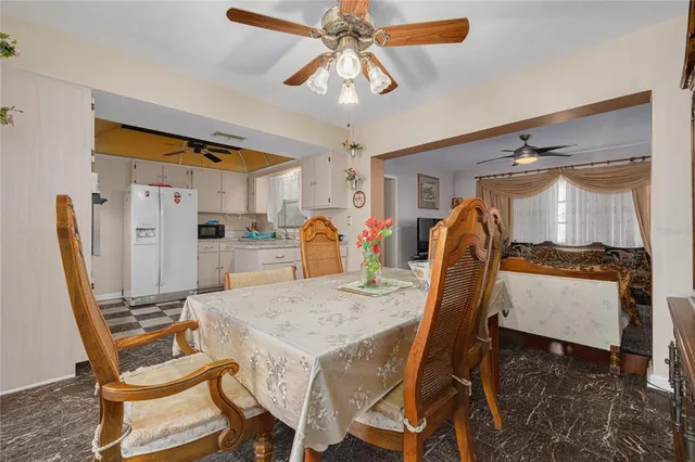 a dining room with furniture and window
