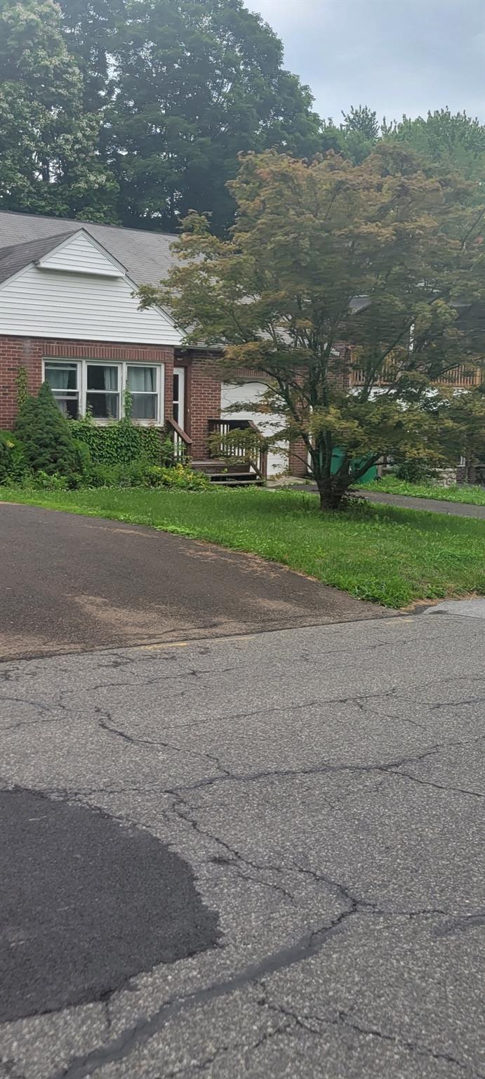 a view of house with yard and ocean view