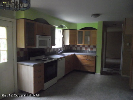 31-7 Crestview Road Blakeslee, PA 18610 - Photo 3 of 14 a kitchen with stainless steel appliances granite countertop a stove a sink and a refrigerator