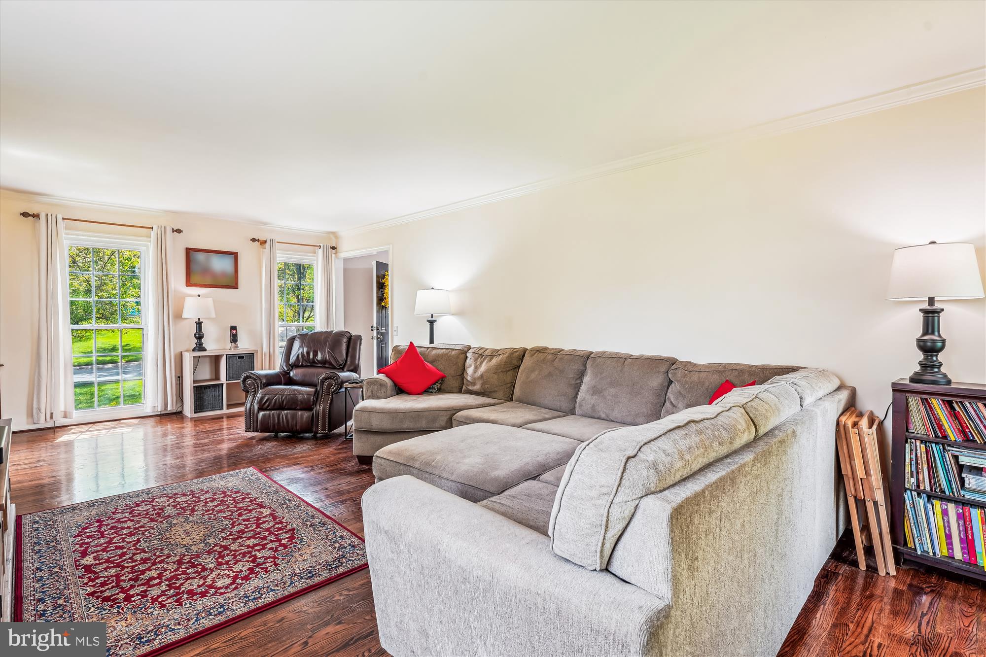 9117 Paddock Lane Potomac, MD 20854 - Photo 11 of 69 a living room with furniture a couch and a bookshelf with wooden floor