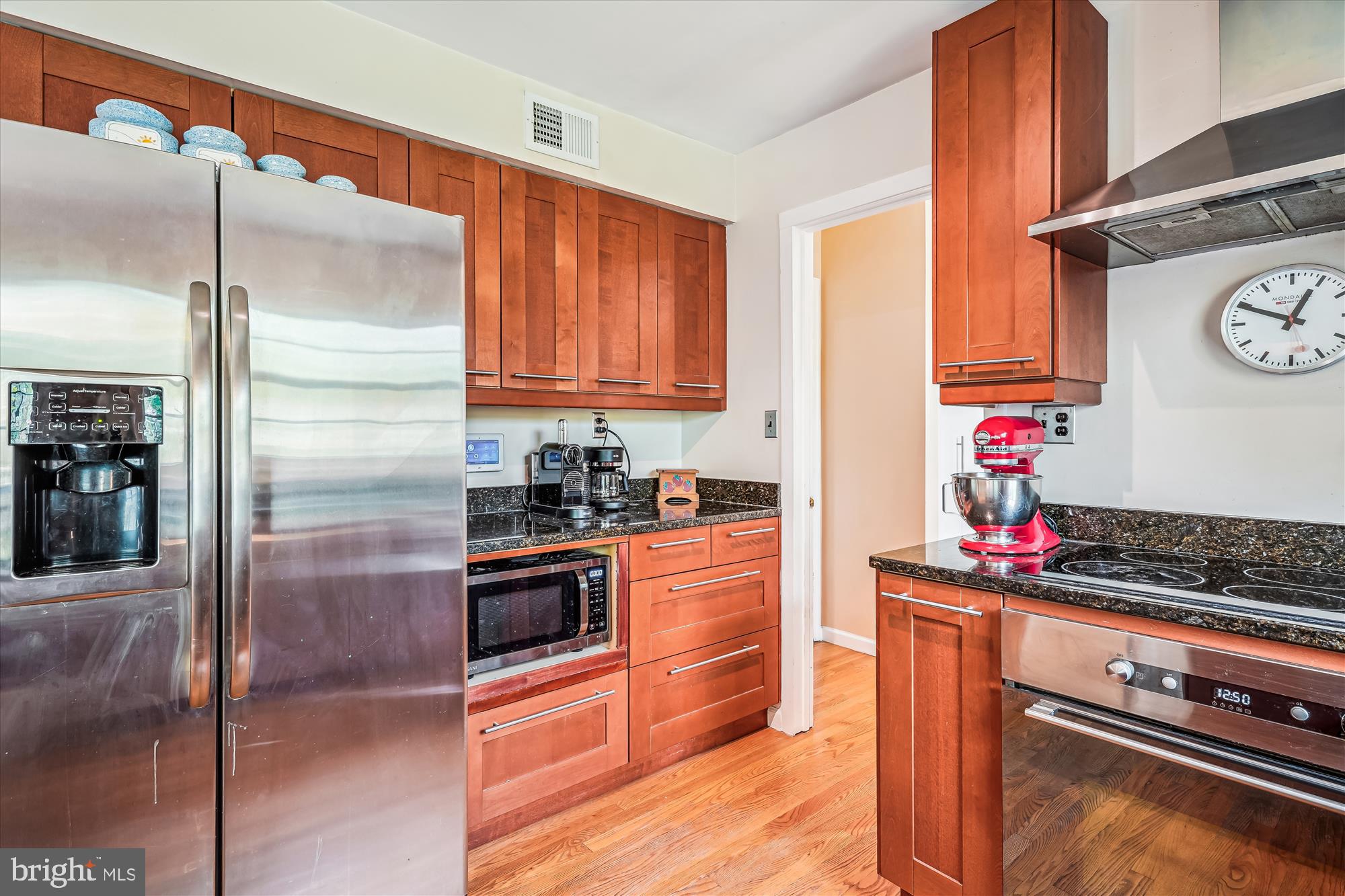 9117 Paddock Lane Potomac, MD 20854 - Photo 19 of 69 a kitchen with stainless steel appliances granite countertop a refrigerator and a stove top oven