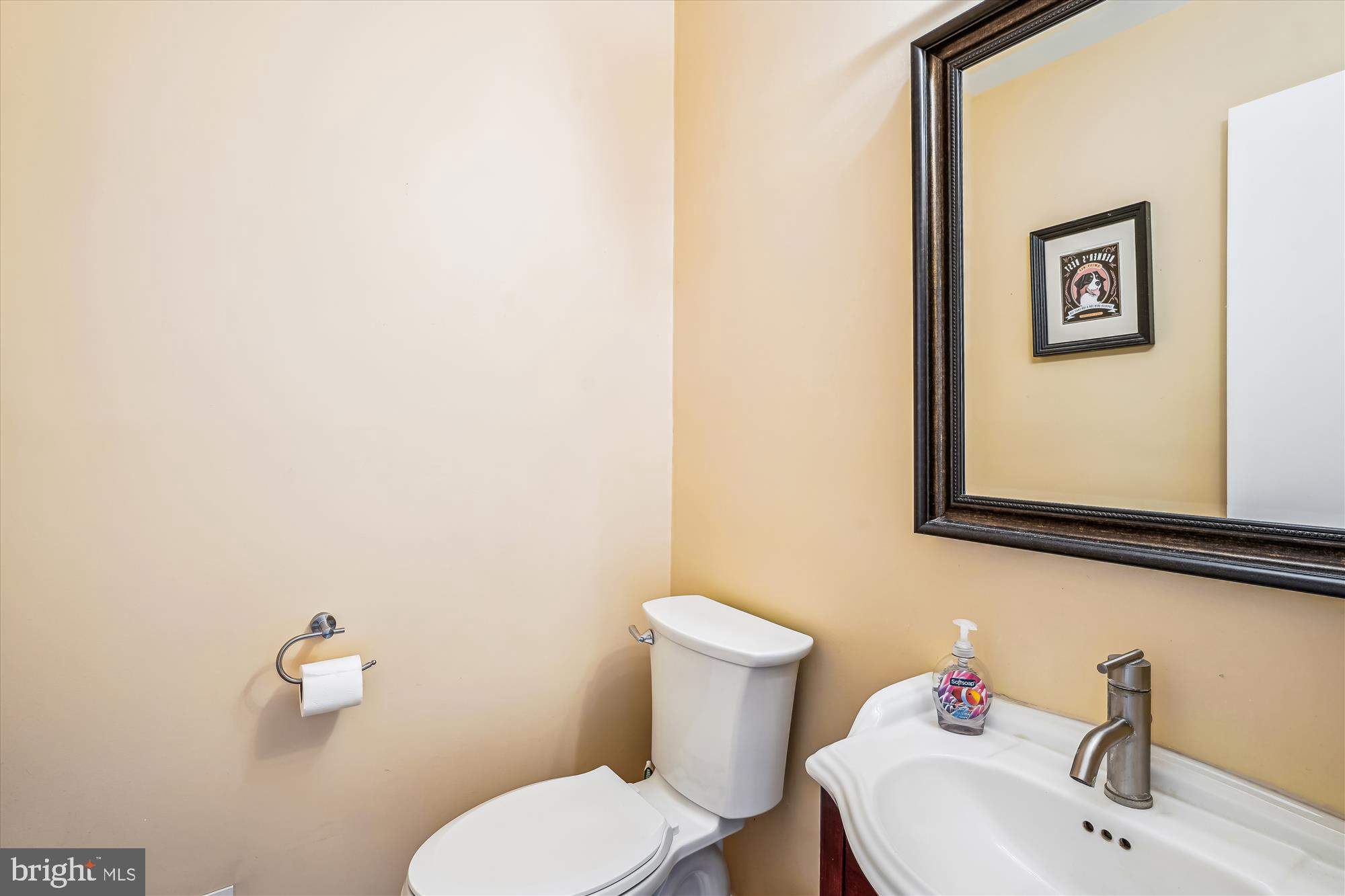 9117 Paddock Lane Potomac, MD 20854 - Photo 22 of 69 a bathroom with a toilet sink and mirror