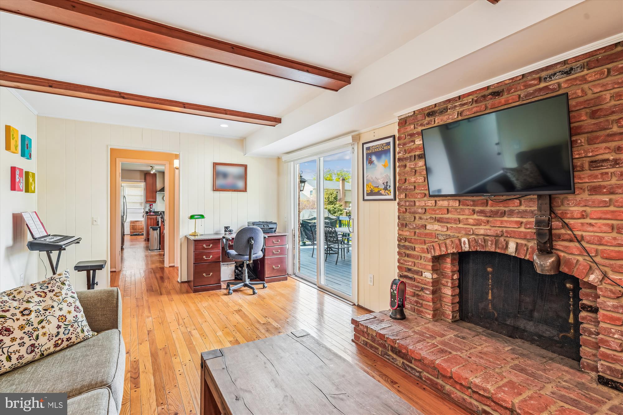 9117 Paddock Lane Potomac, MD 20854 - Photo 25 of 69 a living room with furniture a flat screen tv and a fireplace