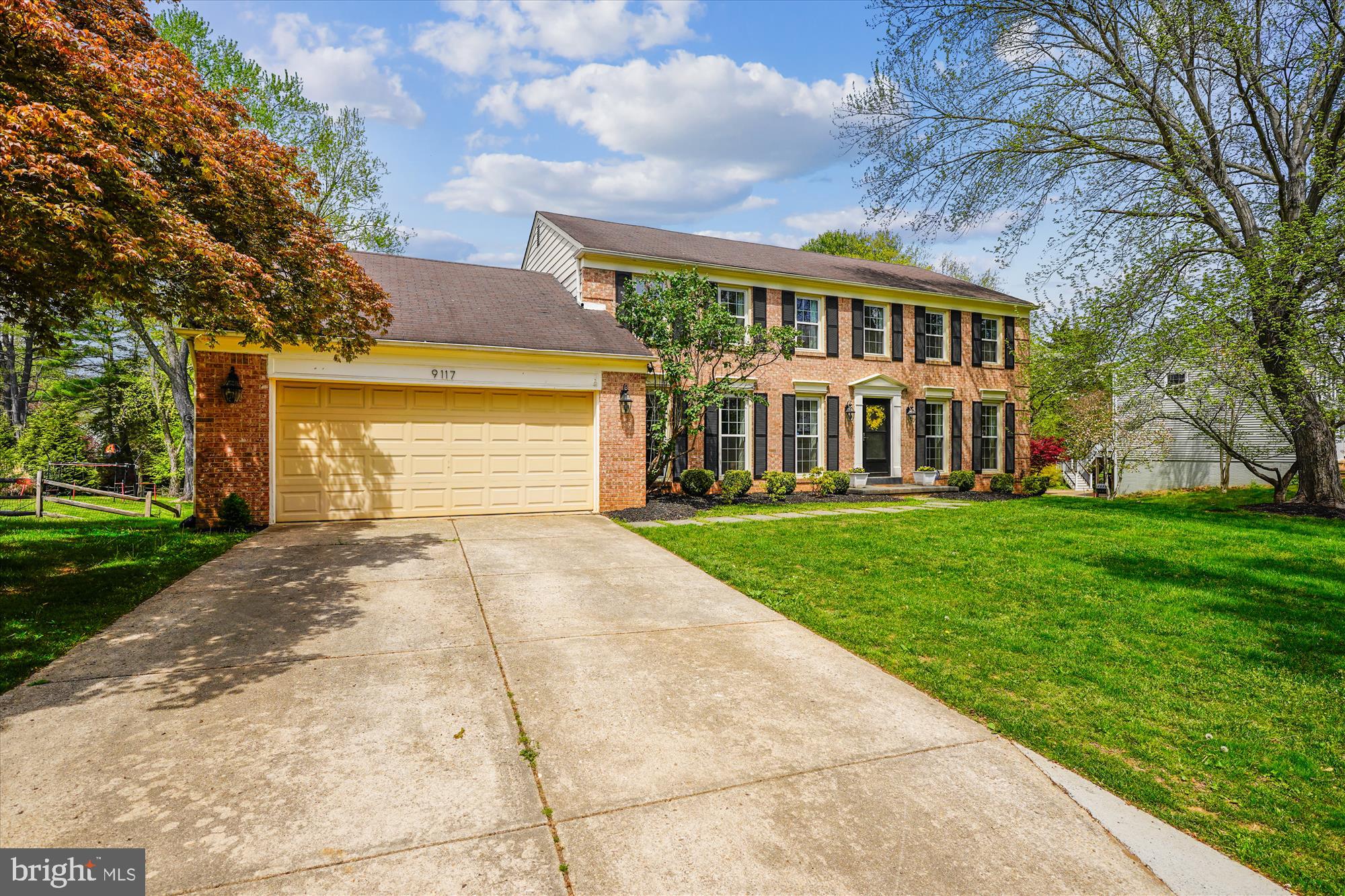 9117 Paddock Lane Potomac, MD 20854 - Photo 3 of 69 a front view of a house with a yard and trees