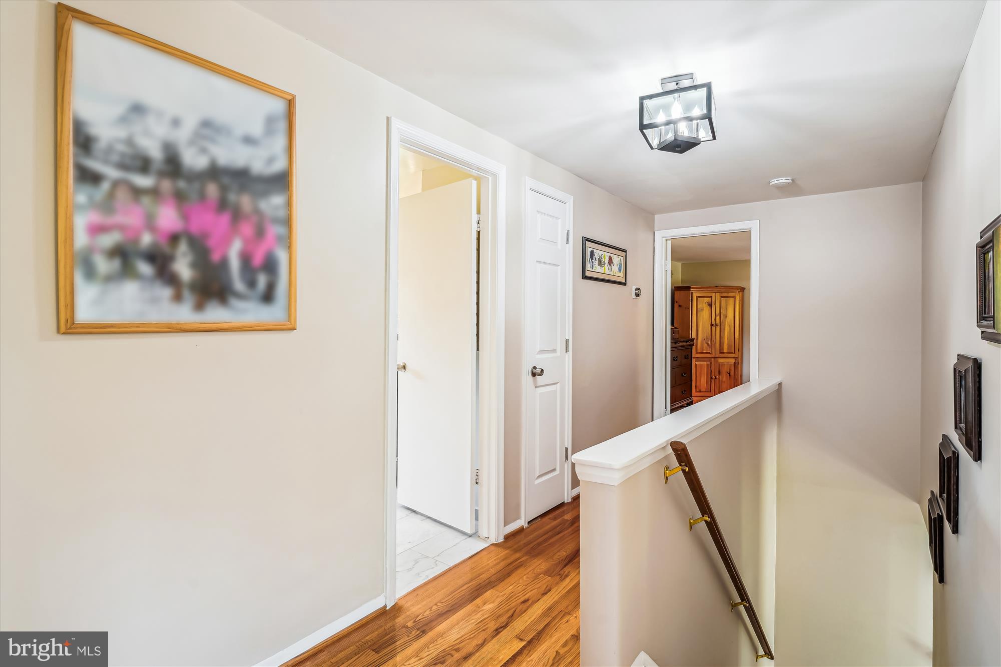 9117 Paddock Lane Potomac, MD 20854 - Photo 32 of 69 a view of a hallway with paintings on the wall