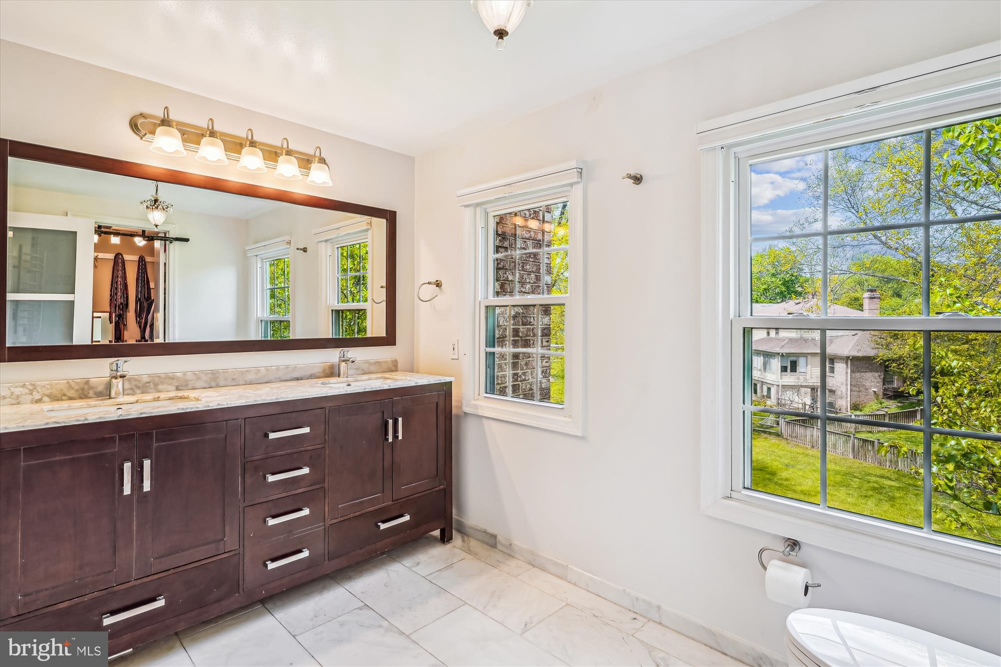 9117 Paddock Lane Potomac, MD 20854 - Photo 37 of 69 a bathroom with a granite countertop double vanity sink a mirror and a shower