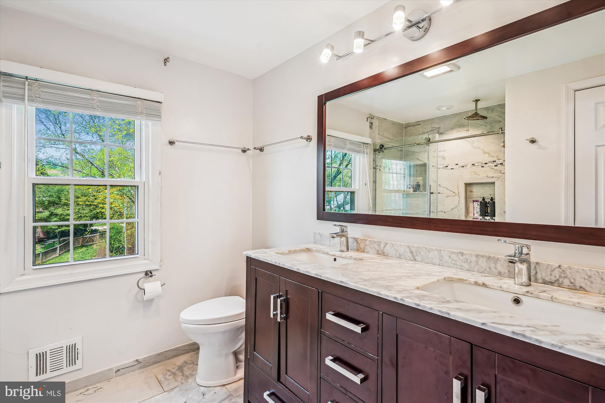 9117 Paddock Lane Potomac, MD 20854 - Photo 45 of 69 a bathroom with a granite countertop toilet sink and a mirror