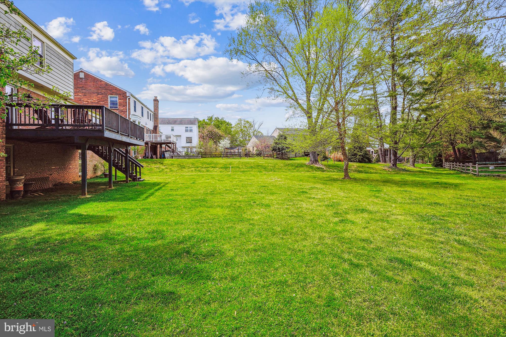 9117 Paddock Lane Potomac, MD 20854 - Photo 7 of 69 a view of a big yard next to a building
